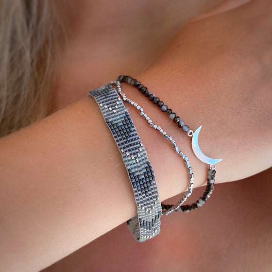 Beaded bracelet handmade with sterling silver crescent moon charm and silver beads