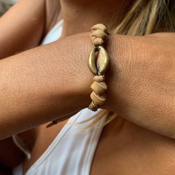brass cowrie shell charm bracelet on suede leather