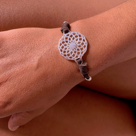 silver Sunflower Sacred Geometry charm bracelet on suede leather